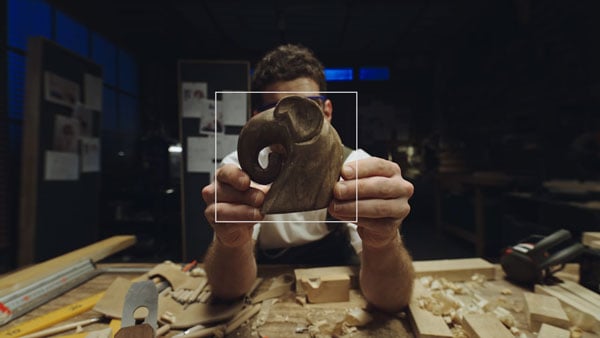 obsbot tiny tracking a wooden elephant that someone is holding up to the camera