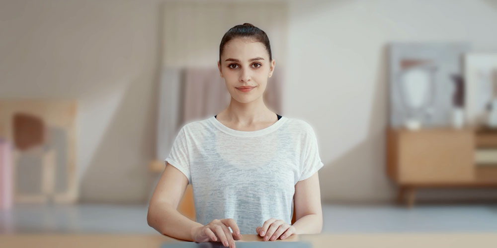 a woman sat at a desk using the blur background feature of the obsbot tiny se