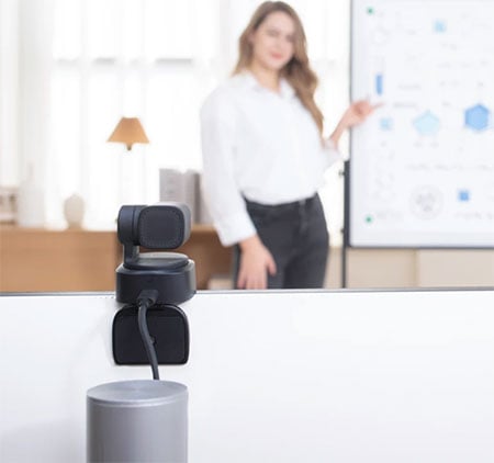 obsbot tiny se mounted on top of a monitor