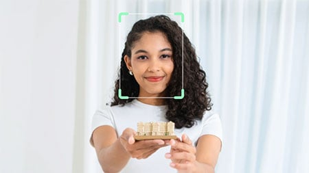 face focus example of a woman holding an ornament using the obsbot tiny se