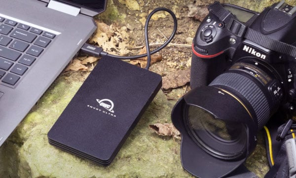 owc drive connected to a laptop next to a camera