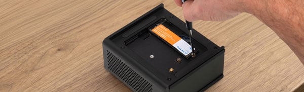 an ssd being installed into the OWC Express 4M2 Ultra desktop RAID storage