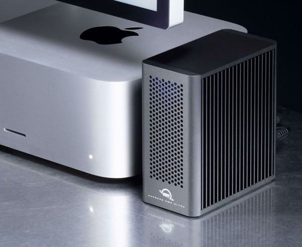 OWC Express 4M2 Ultra Thunderbolt 5 NVMe SSD RAID storage enclosure next to an Apple Mac Studio