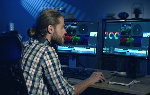 Video editor working on colour grading in a professional post-production studio