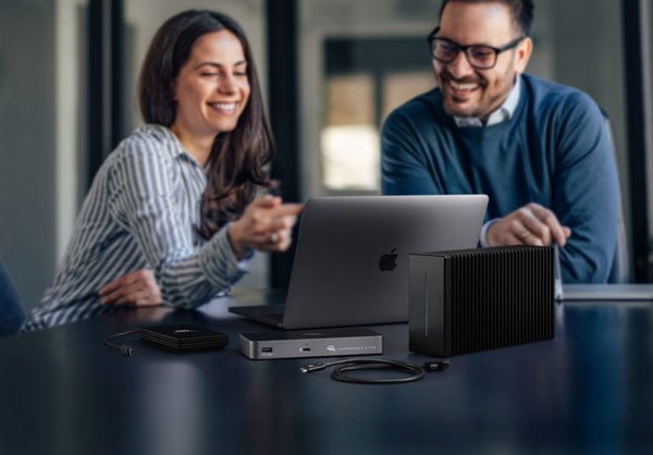 two people looking at a laptop connected to the thunderblade x12