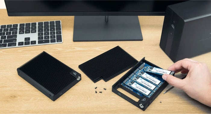 person installing NVMe SSD blade into OWC U2 Shuttle tray
