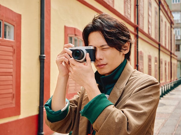 a man taking a photo in a Macau using the Lumix L10 camera