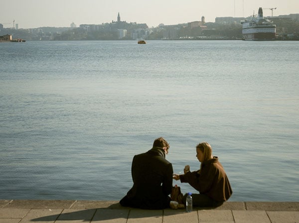 sample image of two people sat on a waterfront