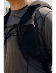 Close up photograph of Peak Design outdoor backpacks Strap chest storage pocket holding iphone 