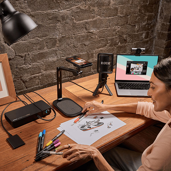 someone recording while drawing at a desk using the rodecaster video core