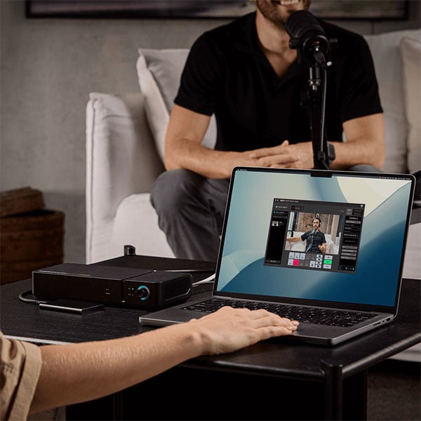 someone recording using a laptop connected to the rodecaster video core