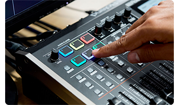 Person pressing audio player control buttons on Roland VR-6HD 