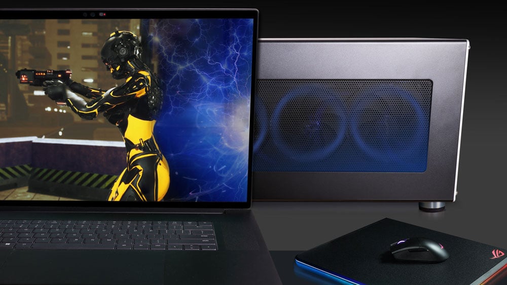 laptop on a black desk connected to the egpu enclosure for gaming