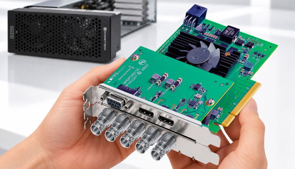 someone holding a blackmagic decklink card