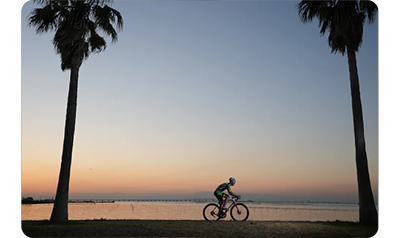 sony a1 sample image road cyclist riding along the oceans edge at sunset