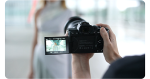 Filmmaker holding Sony A7S III framing a shot