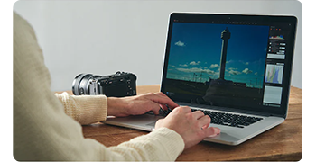photographer with Sony fx3 camera using laptop to remote view images