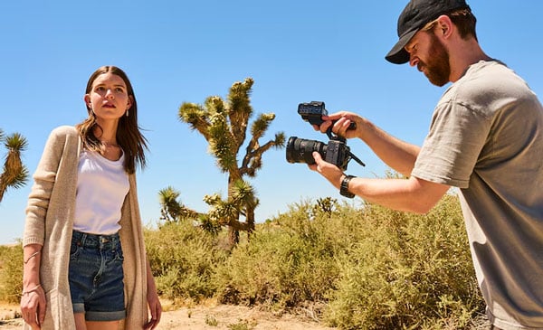 a man filming a woman in the desert using the sony fx5