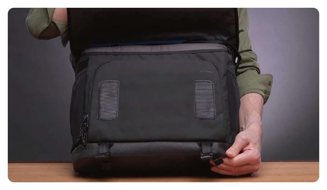 someone opening the tenba messenger bag