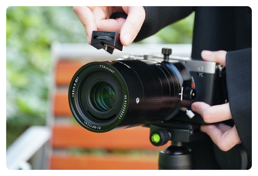 someone attaching the cold shoe mount to the ttartisan macro lens