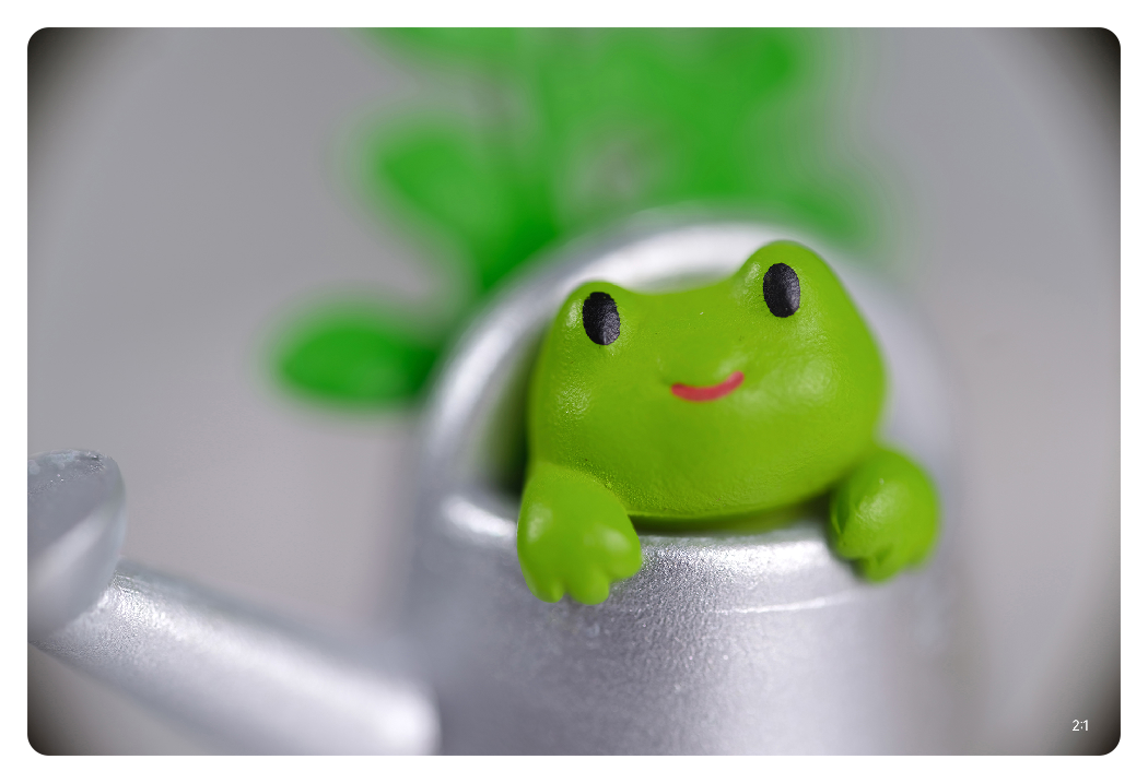 sample image a frog in a watering can toy taken with the ttartisan macro lens