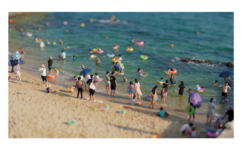 sample photograph of Crowded beach and ocean on a summers days