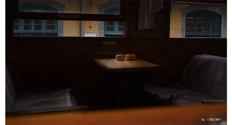 sample photograph of buns sitting on empty cafe table with bench seats infront of window