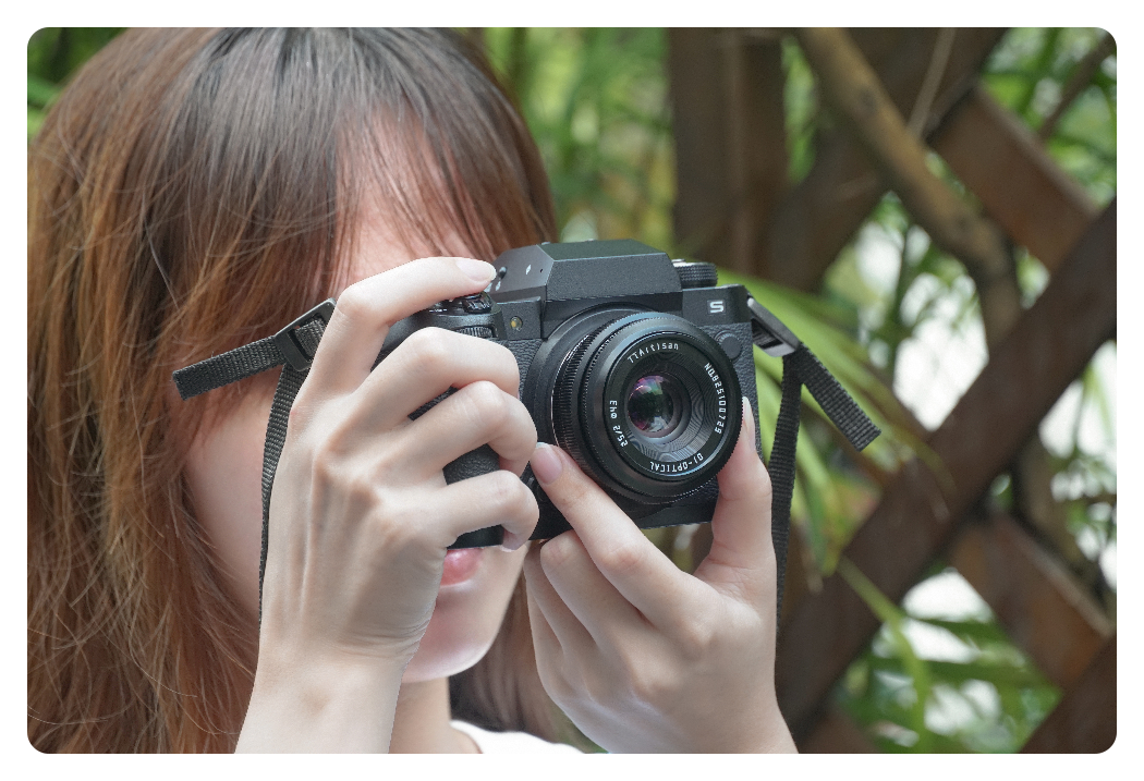 a woman using the ttartisan 25mm f2