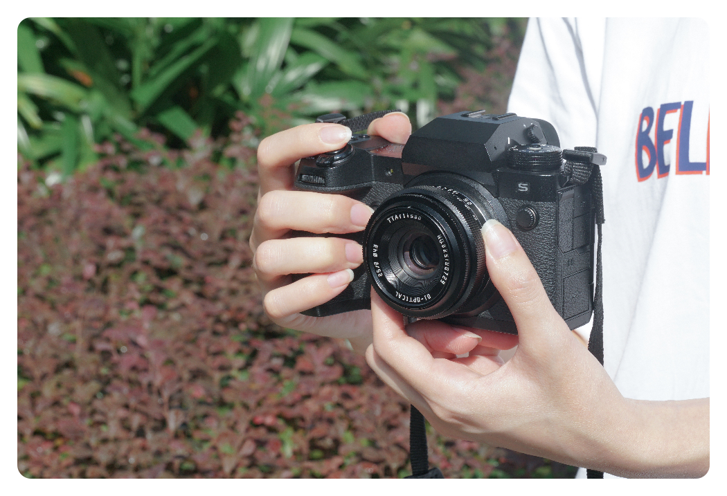 someone holding the ttartisan 25mm f2 