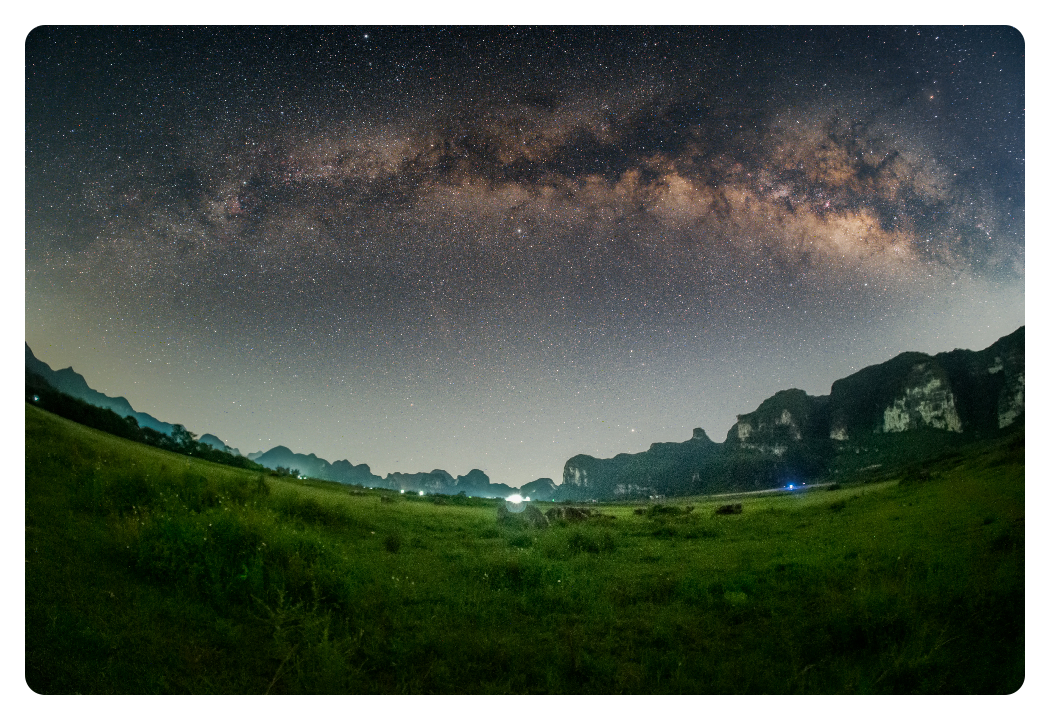 image of a night sky over a field taken using the ttartisan fisheye lens