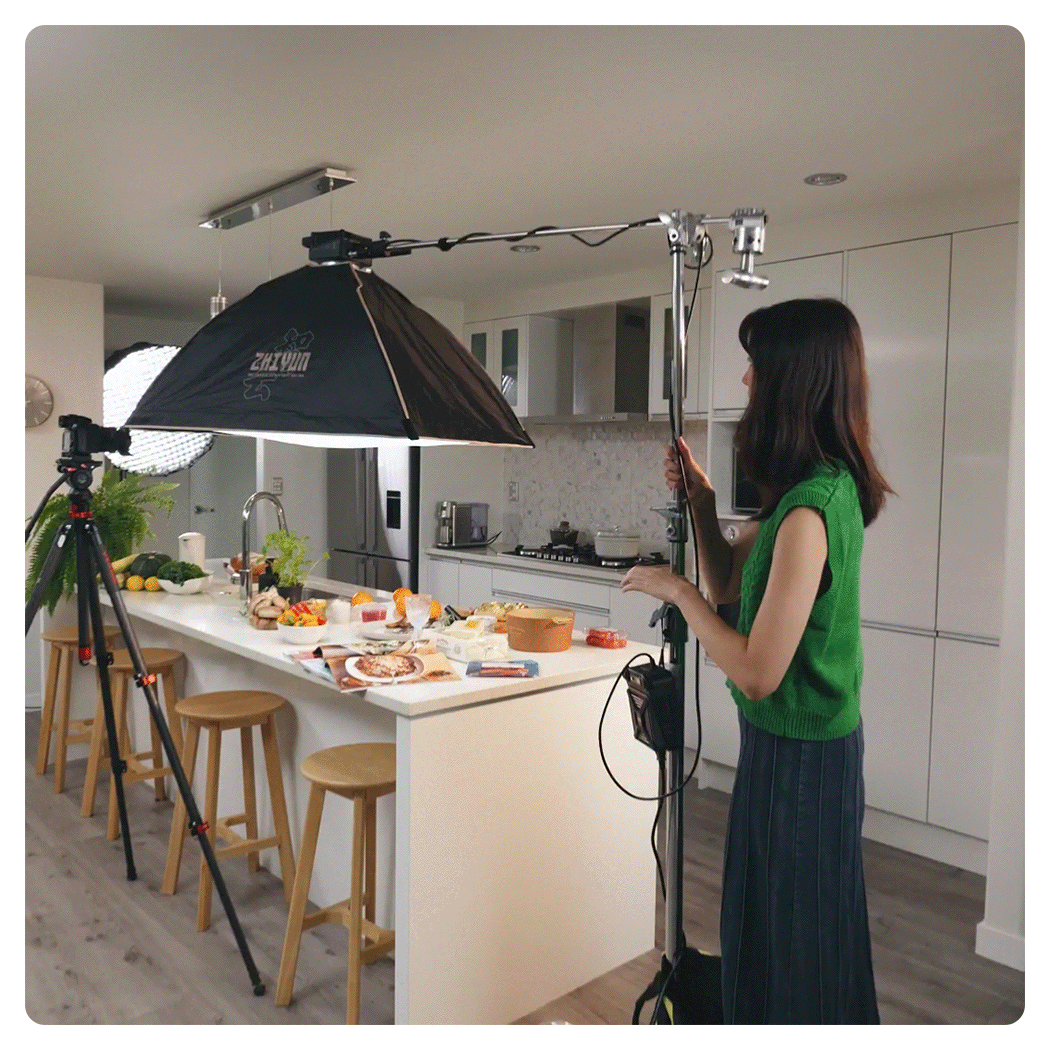 someone attaching the zhiyun cob led light to the ceiling