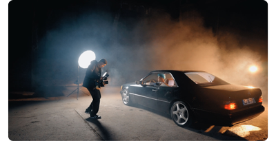 filmmaker shooting a mercedes w140 backlit on set