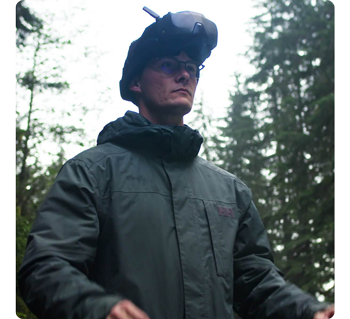 drone pilot standing in forrest wearing DJI Goggles N3 