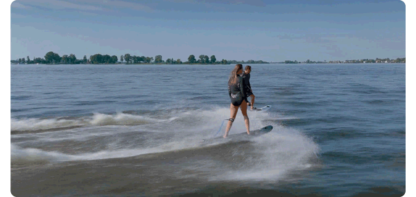 animated gif of two surfers on powered surfboards moving along the water