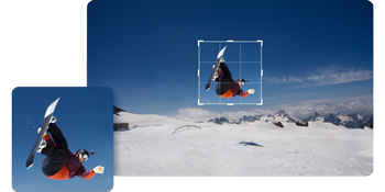 photograph of snowboarder performing backflip against clear blue sky with zoom preview