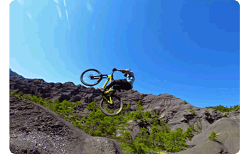 Animated gif of mountain bike rider jumping over rocky outcrop