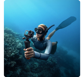 underwater photograph of diver holding DJI osmo action 5 pro recording video