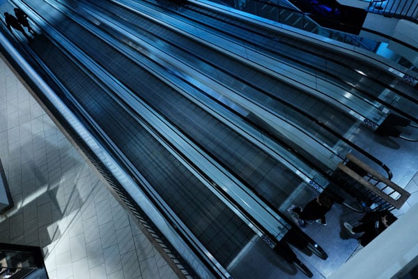 XF16mm f2.8 sample image looking down on 4 escalators under cool blue light