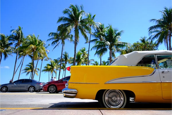XF16mm f2.8 sample image of Yellow and white chevrolet bel air  parked on palm tree lined street in Miami