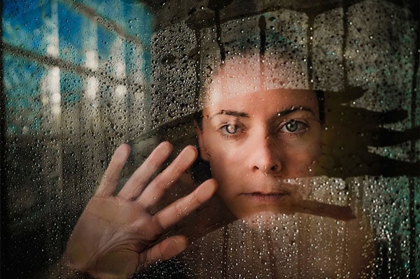 XF18mm F1.4 R LM WR sample portait of womand behind glass panel covered with water droplets