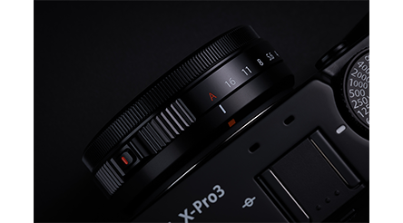 Fujifilm XF27mm Lens mounted on Fuji X-Pro3 camera on a blackbackground
