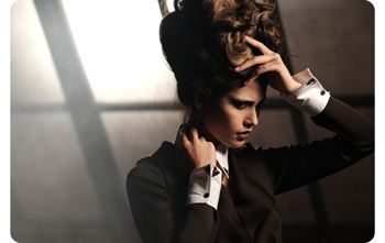 portait photograph of model wearing brown suit holding shirt collar and hair