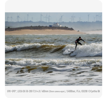 photograph of surfer riding waves on bright sunny beach