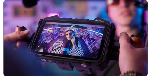 close up of director using Accsoon CineView M7 to preview footage