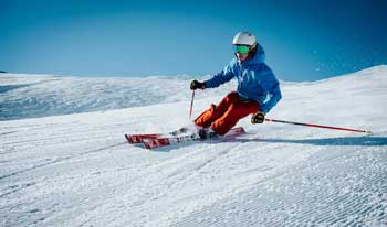 image of skiier travelling down slope