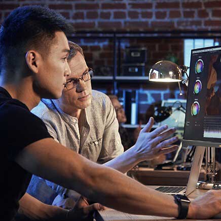 Two colourists reviewing video colour grade on ASUS ProArt monitor