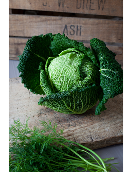 sample image of a savoy cabbage on a wooden box taken with the canon ef 50mm lens