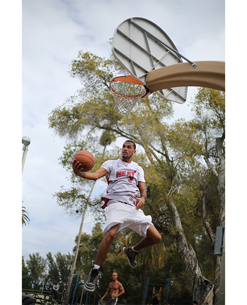 sample image of a basketball player about to dunk taken with the canon ef 50mm