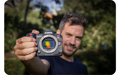 someone holding the canon r5 c camera outside