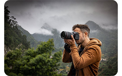 someone taking a photo using the canon r5 c in a rainforest